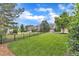 Picturesque backyard with lush green lawn, mature trees, and a wrought iron fence at 237 Bendemeer Ln, Rolesville, NC 27571