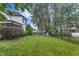 Grassy backyard featuring a privacy fence, lush foliage, and a playset for outdoor fun at 237 Bendemeer Ln, Rolesville, NC 27571