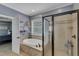 This bright bathroom features a glass shower stall and soaker tub at 237 Bendemeer Ln, Rolesville, NC 27571