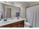Well-lit bathroom featuring double sink vanity with white countertop and matching framed mirror at 237 Bendemeer Ln, Rolesville, NC 27571