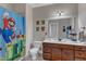 Cute bathroom features a large mirror and Super Mario themed shower curtain at 237 Bendemeer Ln, Rolesville, NC 27571