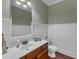 Charming half bathroom with classic wainscoting and a traditional vanity at 237 Bendemeer Ln, Rolesville, NC 27571