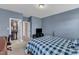 Bedroom with blue walls featuring a bed, walk-in closet and tv on top of a media cabinet at 237 Bendemeer Ln, Rolesville, NC 27571