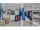 Spacious walk-in closet includes custom shelves, ample hanging storage, and a laundry basket at 237 Bendemeer Ln, Rolesville, NC 27571