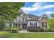 Charming two-story home with stone and siding accents, complemented by lush landscaping and a covered porch at 237 Bendemeer Ln, Rolesville, NC 27571