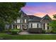 Beautiful two-story home featuring stone accents, a landscaped yard, and a welcoming front porch at 237 Bendemeer Ln, Rolesville, NC 27571
