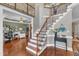 Spacious foyer with hardwood floors, an elegant staircase, and an open view into the adjacent living spaces at 237 Bendemeer Ln, Rolesville, NC 27571