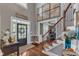 Grand foyer with hardwood floors, staircase, elegant decor, and a view into adjoining rooms at 237 Bendemeer Ln, Rolesville, NC 27571