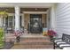 Charming front entrance with a decorative door, brick steps, and colorful potted plants at 237 Bendemeer Ln, Rolesville, NC 27571