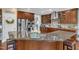 Kitchen with dark wood cabinets, stainless steel appliances, and a functional center island at 237 Bendemeer Ln, Rolesville, NC 27571