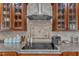 Close up of the cooktop surrounded by granite countertops and tile backsplash at 237 Bendemeer Ln, Rolesville, NC 27571