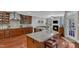 Open kitchen flows into living area with granite countertops, island seating, and fireplace at 237 Bendemeer Ln, Rolesville, NC 27571