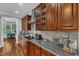 Granite countertops and custom wood cabinets provide ample storage in this kitchen at 237 Bendemeer Ln, Rolesville, NC 27571