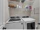 Laundry room with washer and dryer, wire rack shelving and a variety of laundry detergent products at 237 Bendemeer Ln, Rolesville, NC 27571