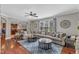 Spacious living room with large sectional, hardwood floors, and an open view to the kitchen at 237 Bendemeer Ln, Rolesville, NC 27571