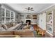 Cozy living room featuring a fireplace, large sectional sofa, and bright windows at 237 Bendemeer Ln, Rolesville, NC 27571