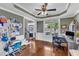 Bright living room featuring hardwood floors, ceiling fan, and a large window for ample natural light at 237 Bendemeer Ln, Rolesville, NC 27571