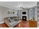 Comfortable living room with cozy fireplace and abundant natural light at 237 Bendemeer Ln, Rolesville, NC 27571