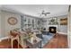 Comfortable living room with a fireplace, large sofa, and natural light from the bright windows at 237 Bendemeer Ln, Rolesville, NC 27571