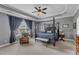 Charming main bedroom with a four-post bed, sitting area, and large windows at 237 Bendemeer Ln, Rolesville, NC 27571