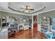 Bright office with hardwood floors, built-in shelves, and stylish decor, creating a functional workspace at 237 Bendemeer Ln, Rolesville, NC 27571