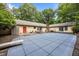 Large backyard with a covered pool, dining set, grill, and a red door leading into the house at 2382 Council Rd, Graham, NC 27253