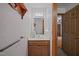 Cozy bathroom featuring a wood vanity, neutral counter, and a wall-mounted mirror at 2382 Council Rd, Graham, NC 27253