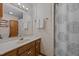 Well-lit bathroom with shower-tub combo, patterned wallpaper and wood vanity at 2382 Council Rd, Graham, NC 27253