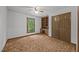 Bedroom featuring carpet, a ceiling fan, built-in shelving and desk, and closet at 2382 Council Rd, Graham, NC 27253