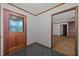 Entryway with black tile flooring and wood door frame open to a carpeted area at 2382 Council Rd, Graham, NC 27253
