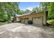 Spacious three-car garage with an expansive concrete driveway and mature trees at 2382 Council Rd, Graham, NC 27253