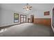 Bright living room boasts vaulted ceilings, carpeted floor, and access to the backyard at 2382 Council Rd, Graham, NC 27253