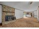 Cozy living room with stone fireplace, wood stove insert, and sliding glass doors to the patio at 2382 Council Rd, Graham, NC 27253