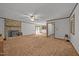 Open living room with carpet, stone fireplace, and access to kitchen and outdoor patio at 2382 Council Rd, Graham, NC 27253