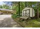 View of the shed near the garage and driveway surrounded by lush greenery at 2382 Council Rd, Graham, NC 27253