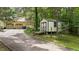 The shed sits alongside a long driveway surrounded by green landscape at 2382 Council Rd, Graham, NC 27253