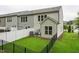 Large backyard with lush green grass, patio seating, fenced perimeter, and landscaping at 241 White Oak Ridge Dr, Garner, NC 27529