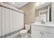 Full bathroom with white cabinets, quartz countertop, and shower with striped curtain at 241 White Oak Ridge Dr, Garner, NC 27529