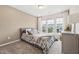 Bright bedroom with a large window, gray upholstered bed, and soft, neutral decor at 241 White Oak Ridge Dr, Garner, NC 27529