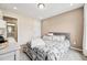 Comfortable bedroom with soft colors, plush bedding, carpet and an adjacent bathroom at 241 White Oak Ridge Dr, Garner, NC 27529