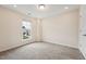 Carpeted bedroom with neutral walls, window and closet featuring a smooth modern door at 241 White Oak Ridge Dr, Garner, NC 27529