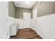 Welcoming entryway featuring wainscoting, wood floors, a storage bench, and a white front door at 241 White Oak Ridge Dr, Garner, NC 27529
