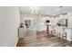 Bright kitchen with white cabinets, stainless appliances, granite counters, and hardwood floors with island and bar stool seating at 241 White Oak Ridge Dr, Garner, NC 27529