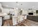 Modern kitchen with white cabinets, stainless appliances, granite countertops, and seating at the island at 241 White Oak Ridge Dr, Garner, NC 27529