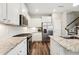 Bright and modern kitchen featuring stainless steel appliances, white cabinets, and granite countertops at 241 White Oak Ridge Dr, Garner, NC 27529