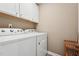 Convenient laundry area with white cabinets, modern washer and dryer set, and neutral walls at 241 White Oak Ridge Dr, Garner, NC 27529