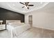 Spacious main bedroom with a tray ceiling and fan, bedside table, and access door to main bath and walk-in closet at 241 White Oak Ridge Dr, Garner, NC 27529