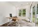 Bright office space featuring wood floors, a large window with backyard view, and a modern desk and seating at 241 White Oak Ridge Dr, Garner, NC 27529