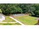 Aerial view of a beautiful in-ground pool surrounded by a fenced yard and mature trees at 2523 Lovette Ln, Graham, NC 27253