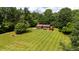 A sprawling estate with a well-manicured lawn and mature trees create a private and idyllic setting at 2523 Lovette Ln, Graham, NC 27253